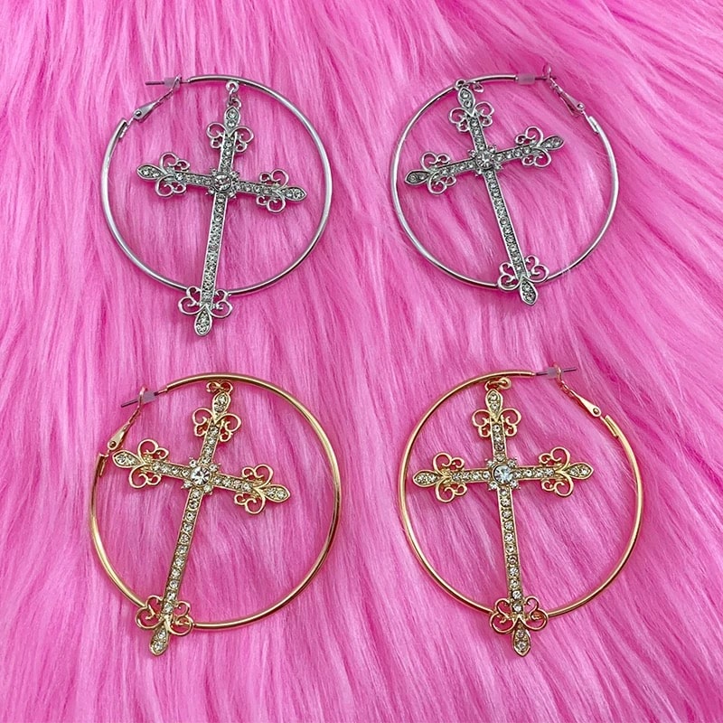 Punk aesthetic gold cross earrings with crystal hoops. Y2K-inspired jewelry for bold fashion statements.