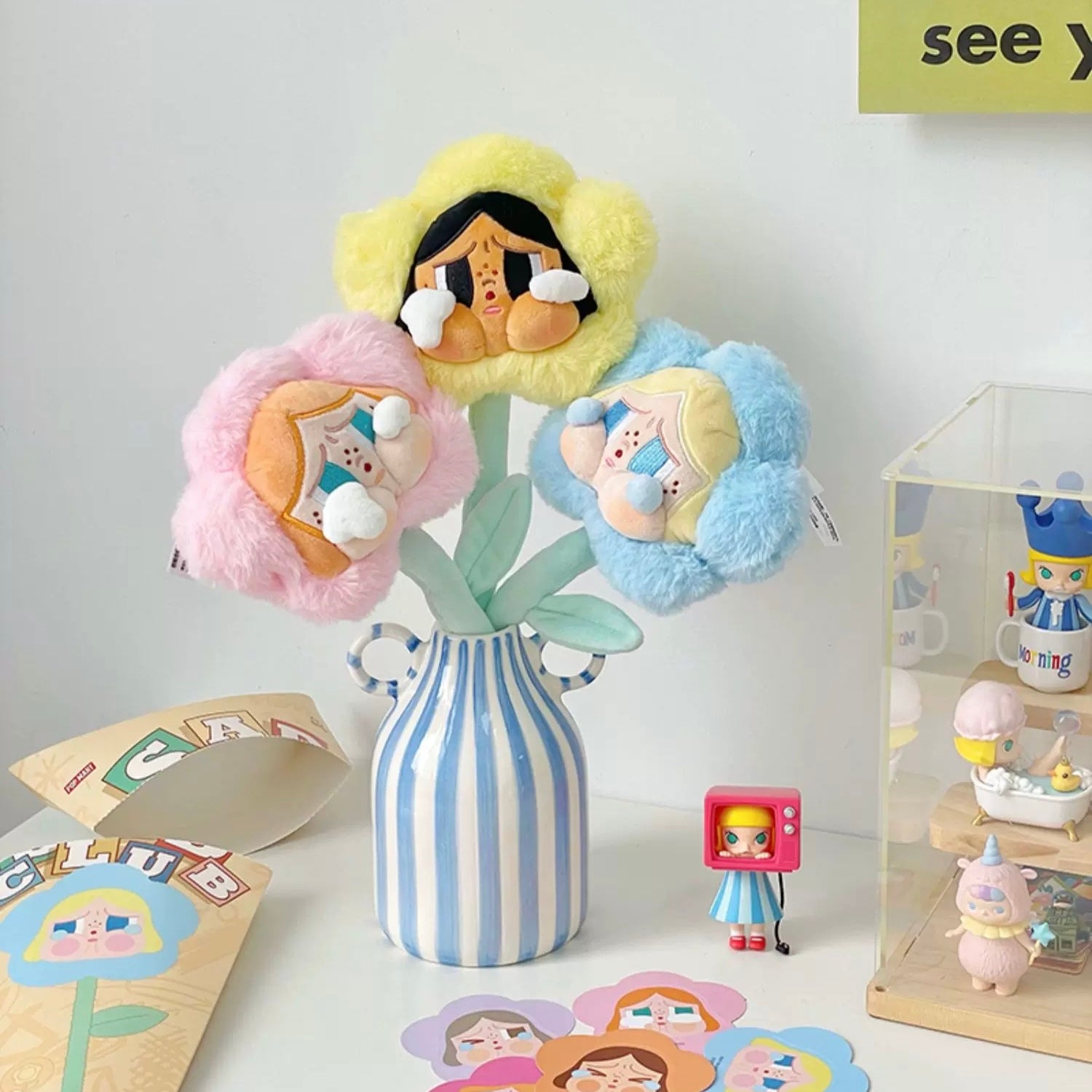 Double-handled ceramic vase styled on dorm bookshelf with flowers