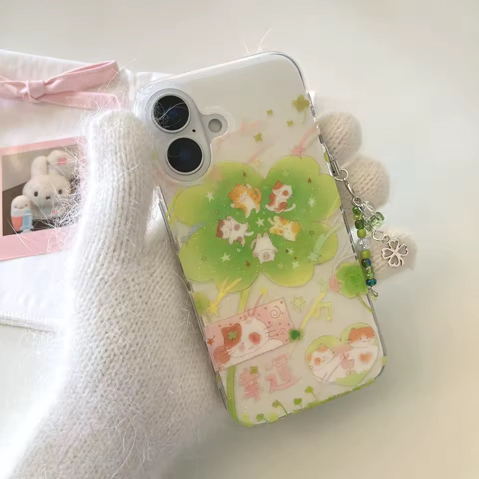 Phone case with cartoon design and charm on a white surface
