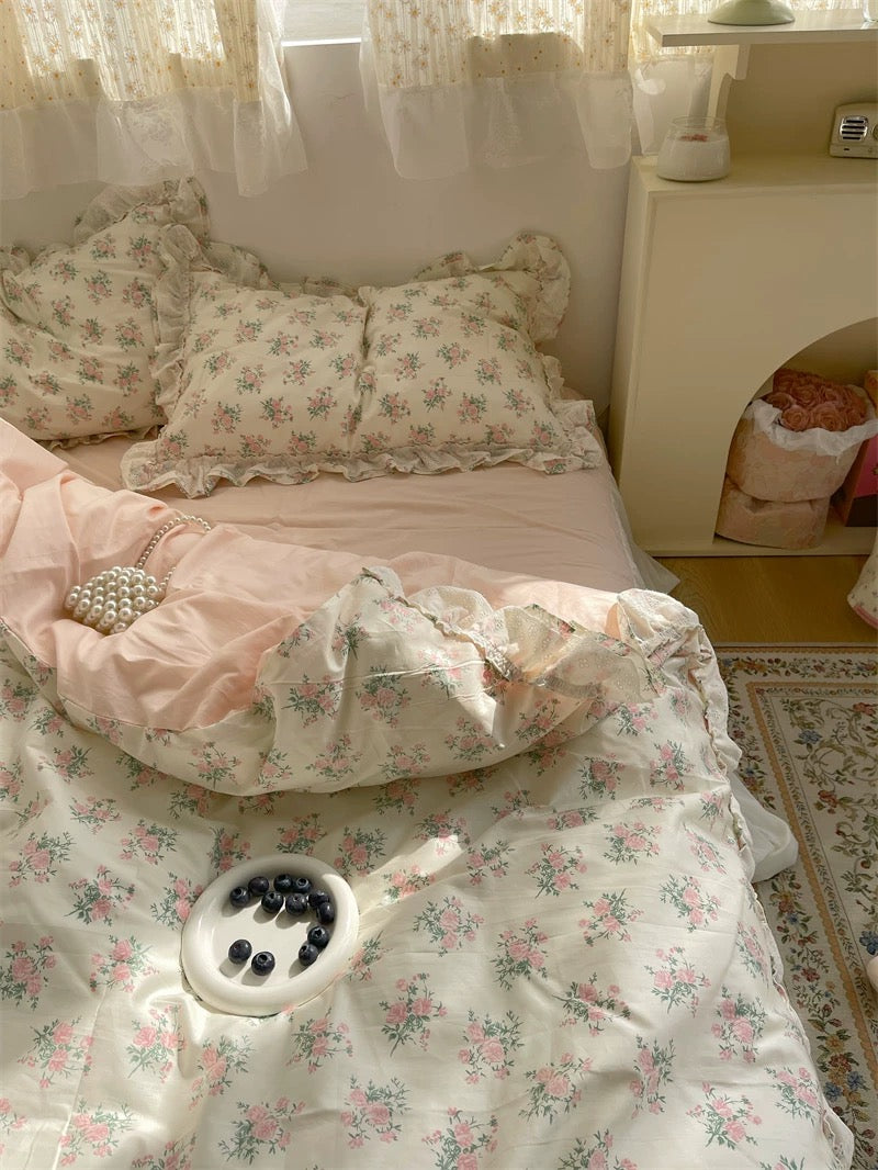 Romantic floral lace ruffle duvet cover set in pastel pink and cream tones, styled for a dreamy cottagecore bedroom.