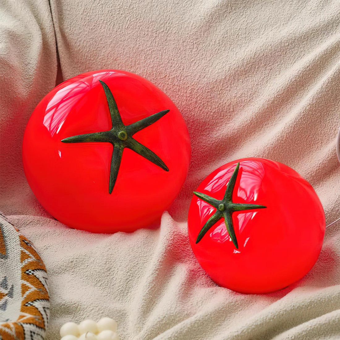 Red circular light with a black star-like design on a white surface.