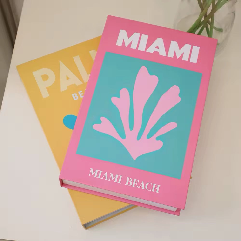 Decorative book spines in pastel tones neatly displayed on a shelf next to minimalist ceramic decor