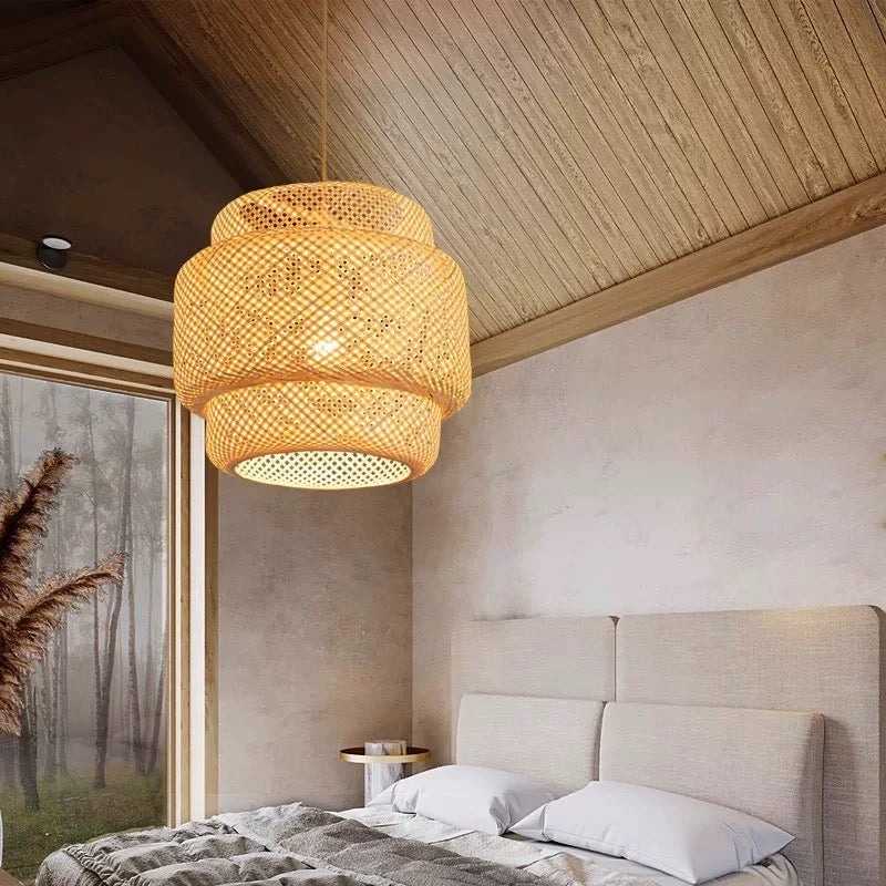 Handwoven bamboo pendant light casting warm glow in modern Japandi bedroom.