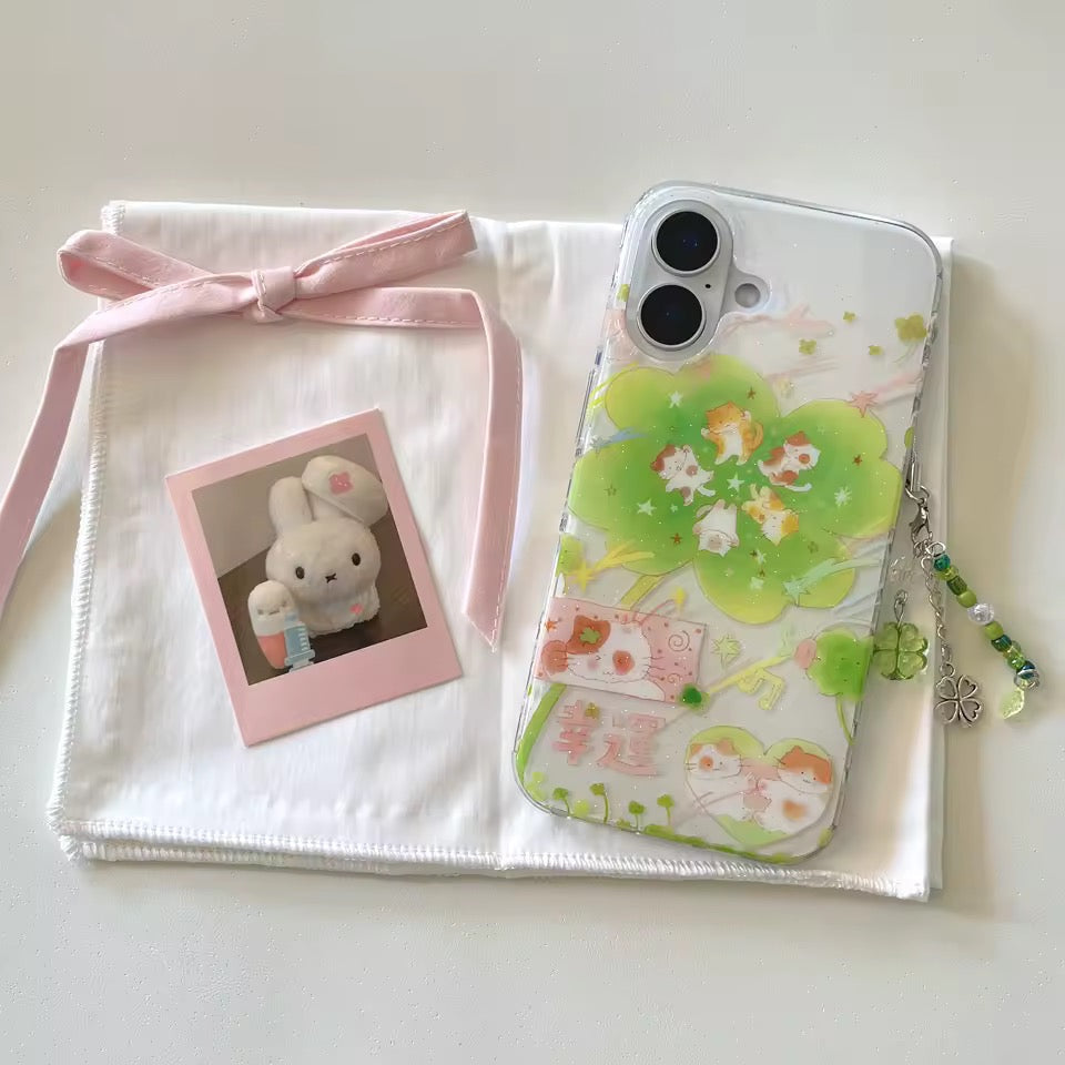 Phone case with green design, photo frame, and plush toy on a white background
