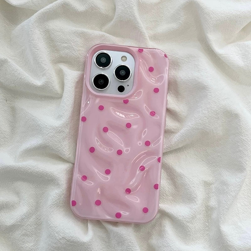 Full-coverage iPhone case with glossy surface and fun polka dot pattern