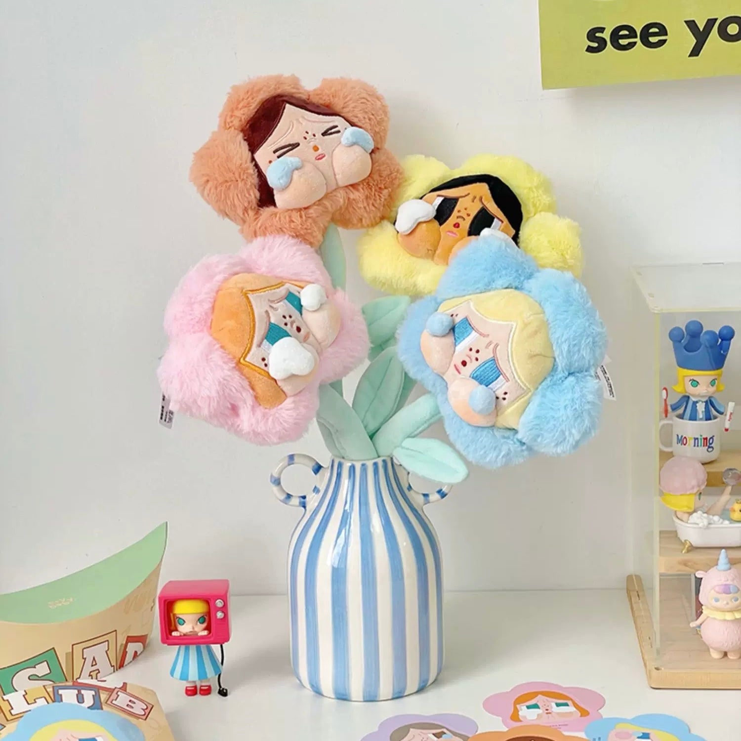 Hand-painted striped ceramic vase with dual handles styled on wooden shelf