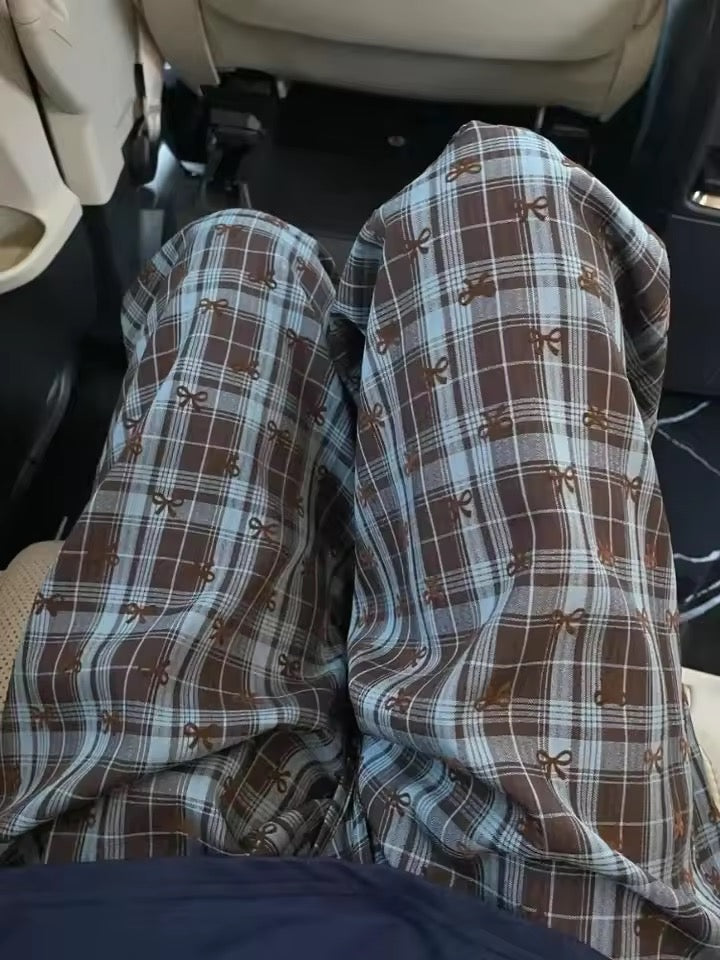 Plaid pants with brown and blue pattern inside a vehicle.
