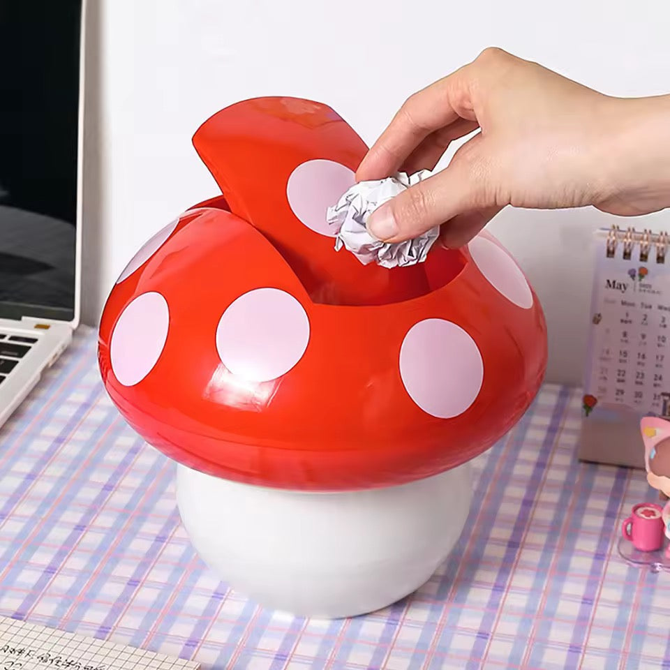 Mushroom-shaped trash can with a hand disposing of waste on a checkered tablecloth.