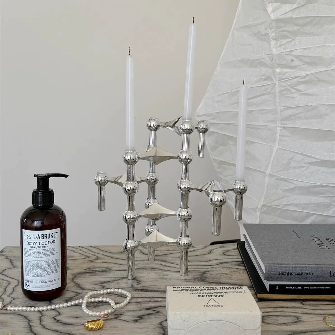 The candlestick on a mantelpiece, complementing minimalist décor.
