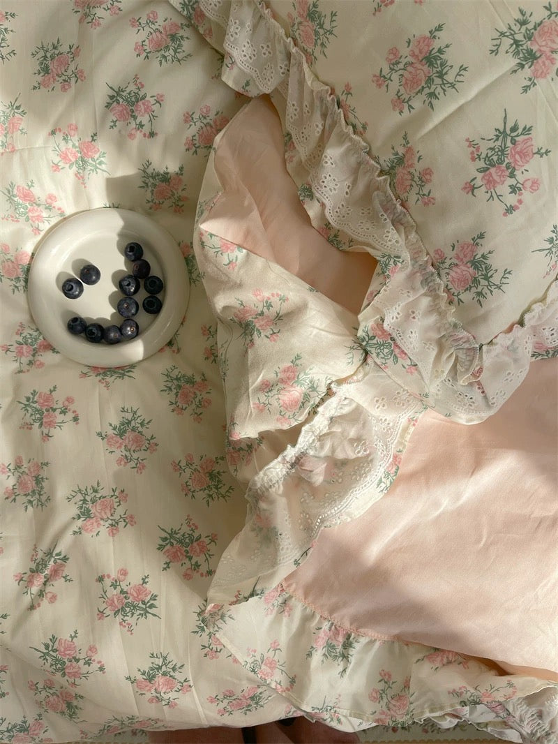 Romantic floral lace ruffle duvet cover set in pastel pink and cream tones, styled for a dreamy cottagecore bedroom.