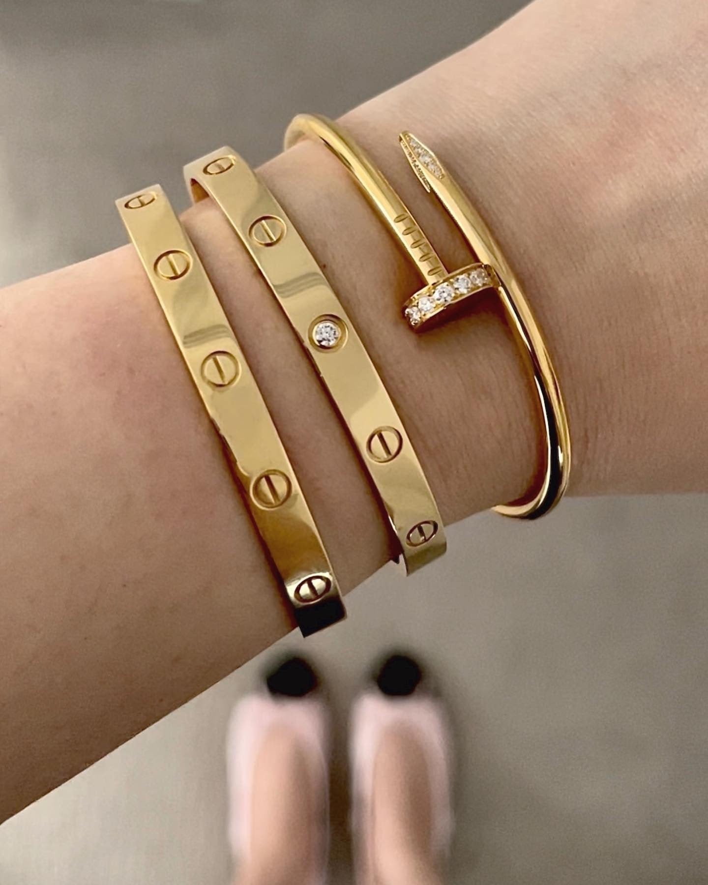 Woman wearing the Nail Bracelet in gold, showcasing minimalist design