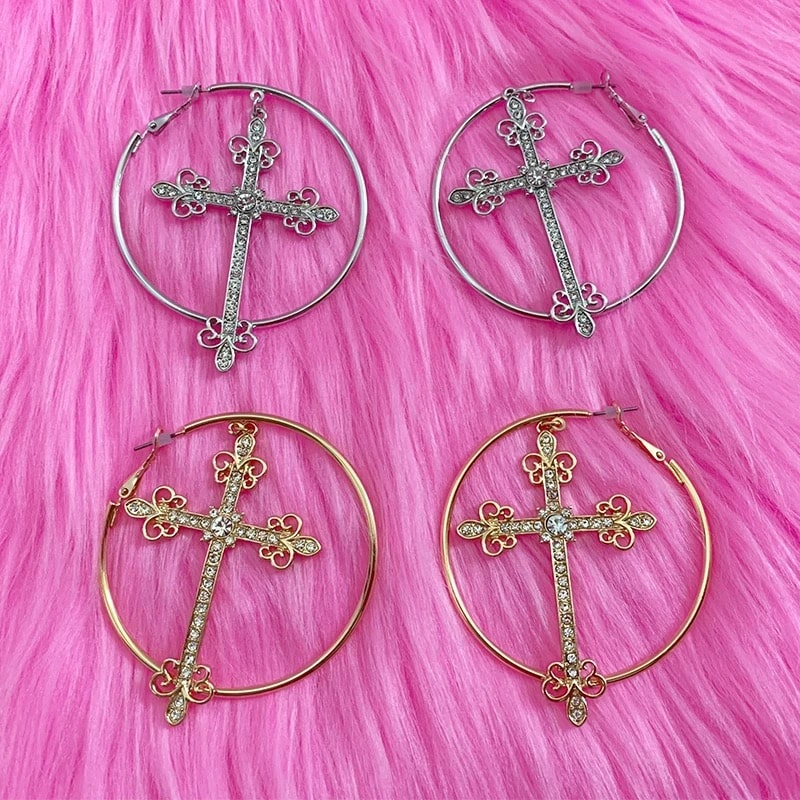 Punk aesthetic gold cross earrings with crystal hoops. Y2K-inspired jewelry for bold fashion statements.