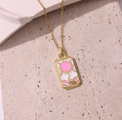Pink tarot card pendant with intricate illustrations, a unique piece of jewelry.