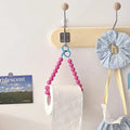 Y2K-inspired pink tissue holder adorned with elegant beads for a touch of glam.