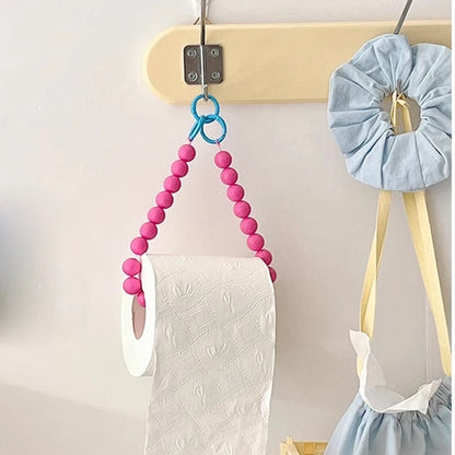 Chic pink tissue holder featuring delicate beading, perfect for a trendy bathroom.