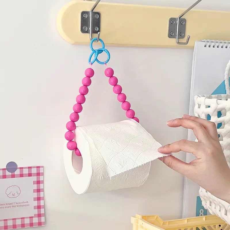 Y2K bathroom essential: Pink hanging tissue holder with stylish bead detailing.