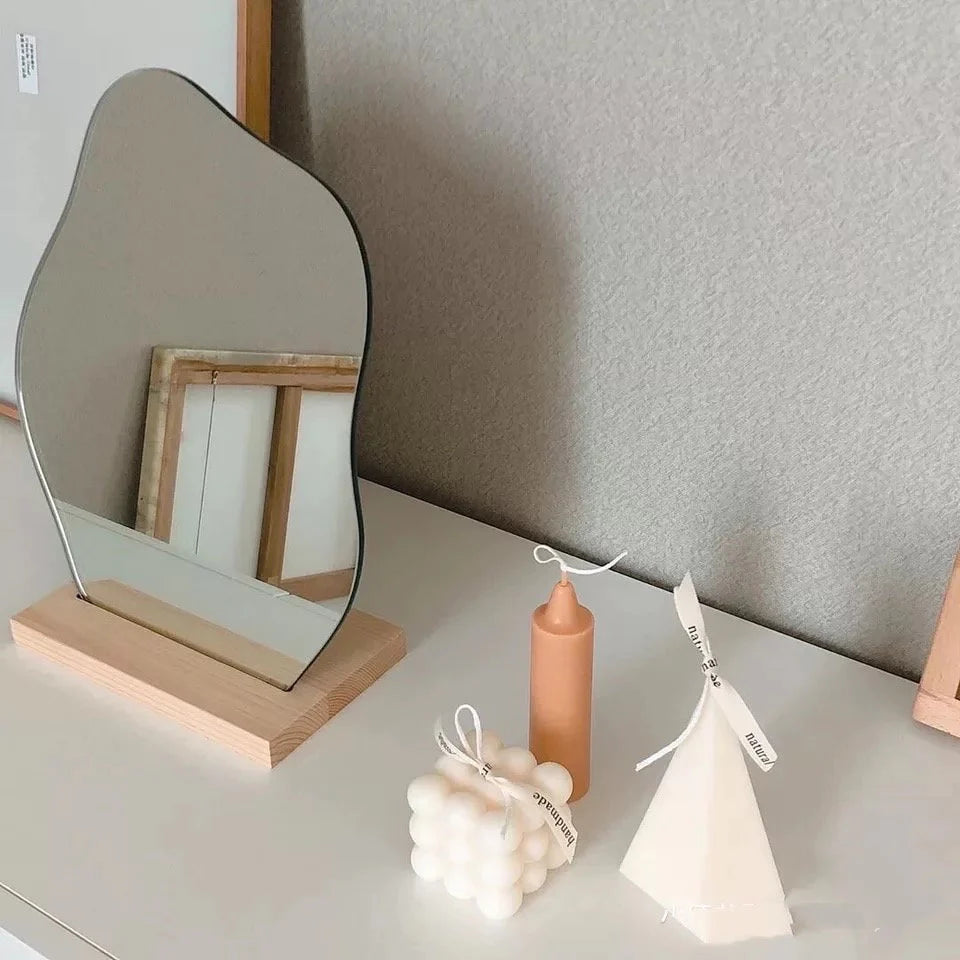 Cloud shape decorative mirror with frameless acrylic design. Stylish vanity table mirror with wooden stand for makeup or room decor.