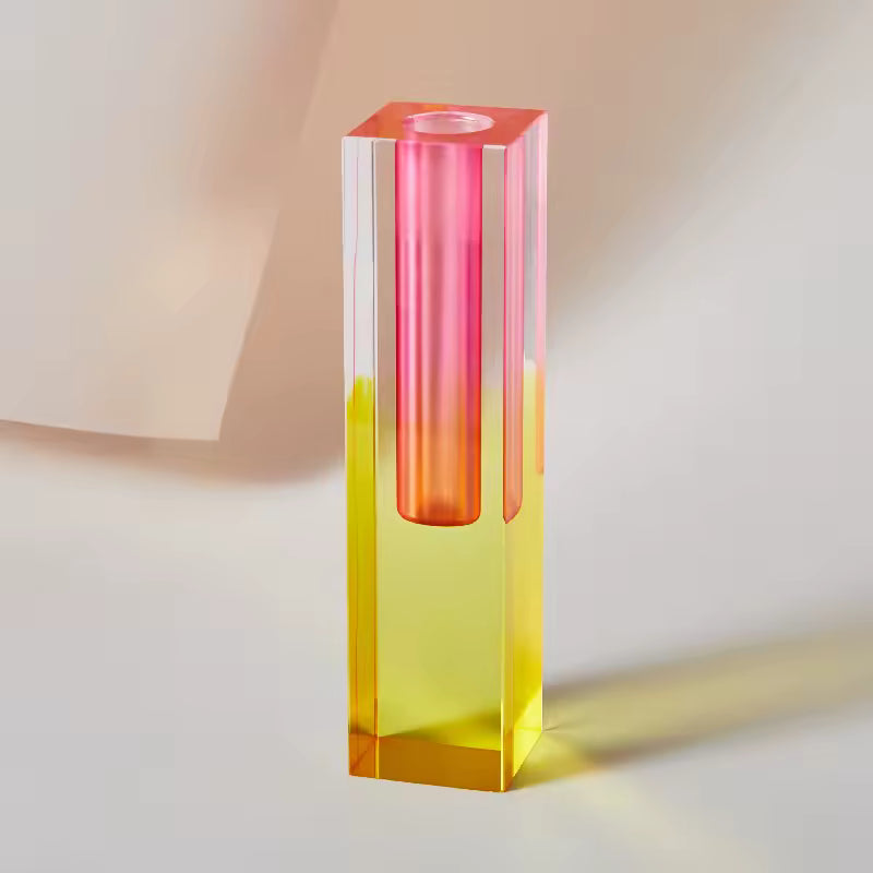 Colorful cylindrical glass object with gradient colors on a neutral background
