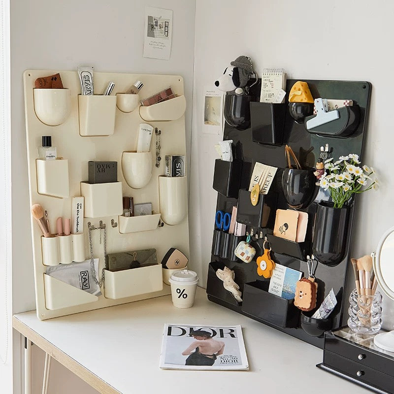 Wall-mounted organizer with hooks for kitchen and office supplies. 16-compartment design for versatile storage.