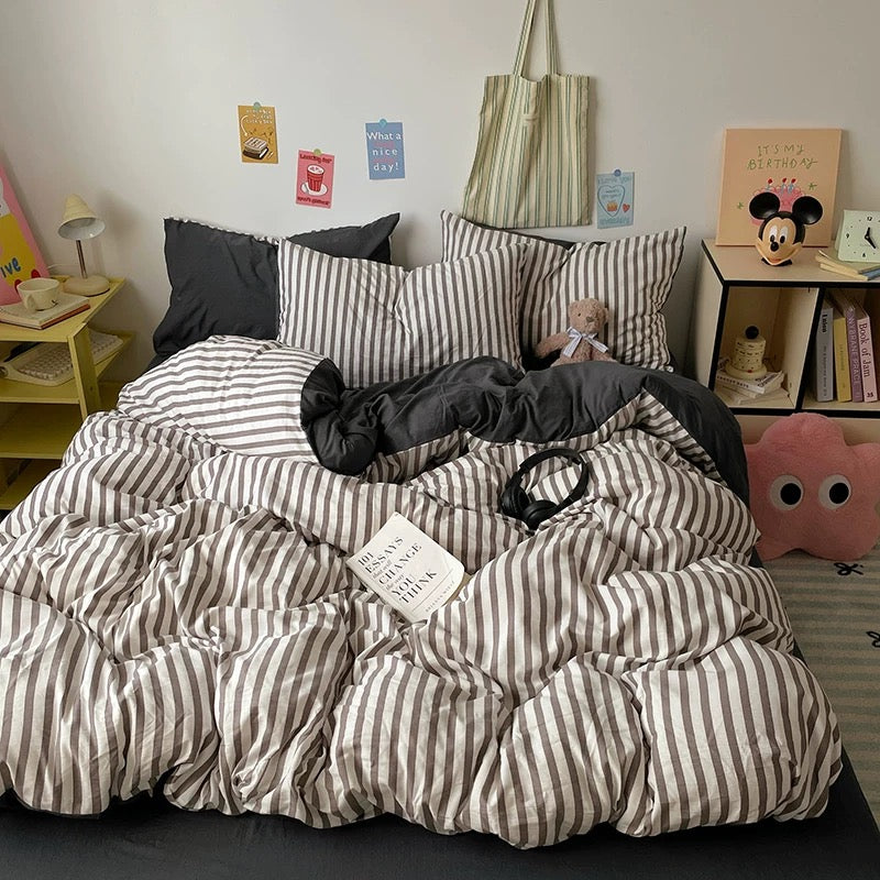 Cozy black and white stripe comforter cover set styled with plush decor and posters