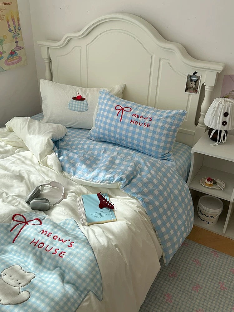 Kawaii dorm bedding with gingham pillow and cat applique embroidery.