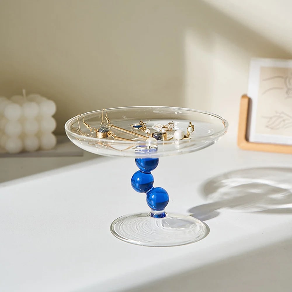 Curved glass jewelry tray with a minimalist design, perfect for rings and accessories