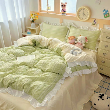 Bedroom with green and white bedding, stuffed animals, and a clock on the wall.
