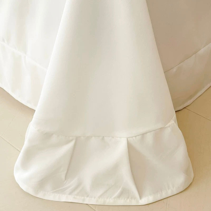 White skirt with a ruffled hem on a beige background