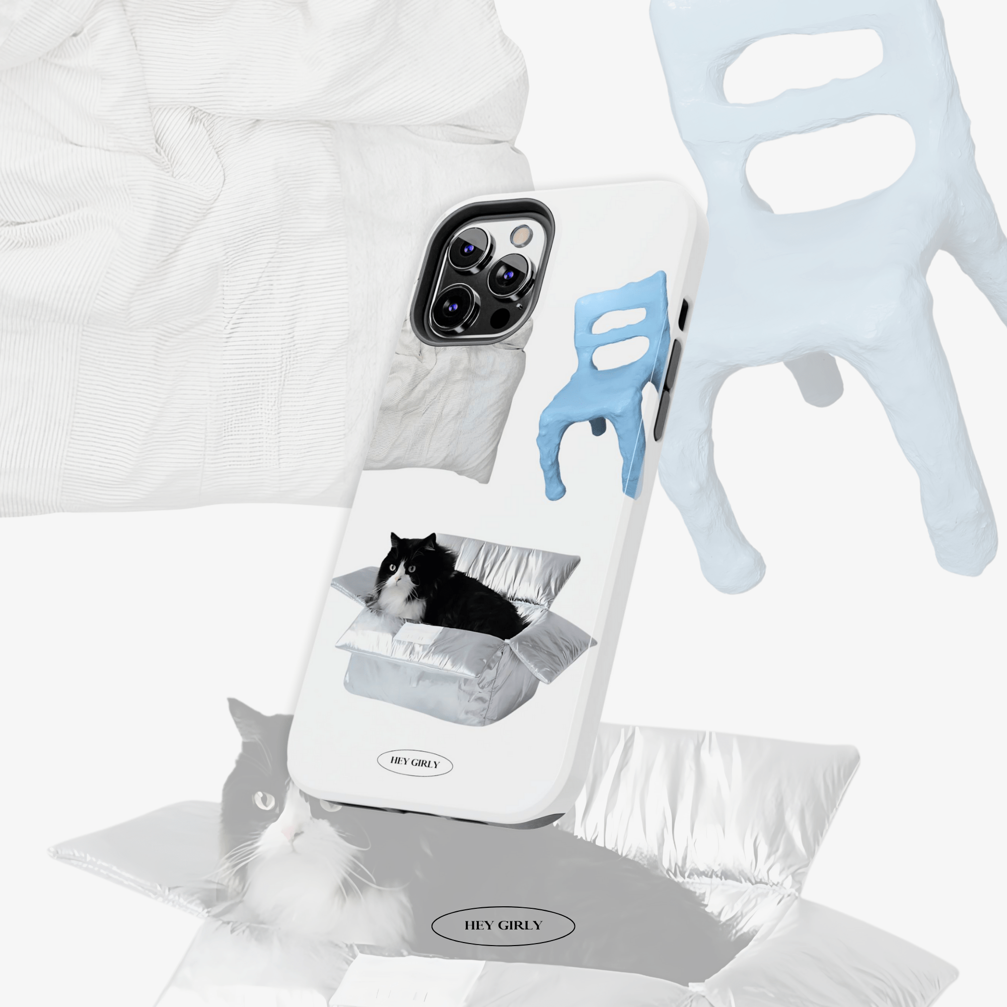 Phone case with cat design, grooming tool, and pet bed on a white background