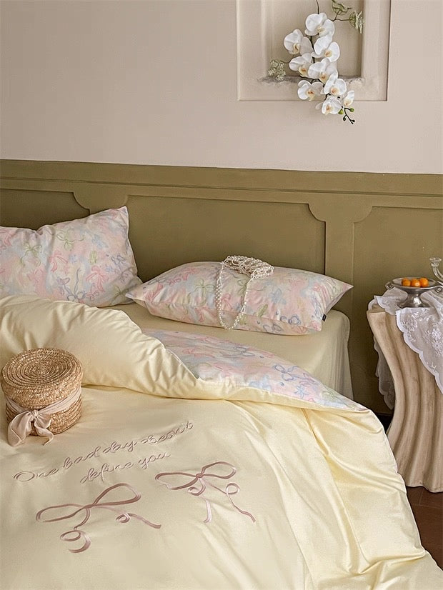 Neatly made bed with decorative pillows and a headboard in a bedroom setting.