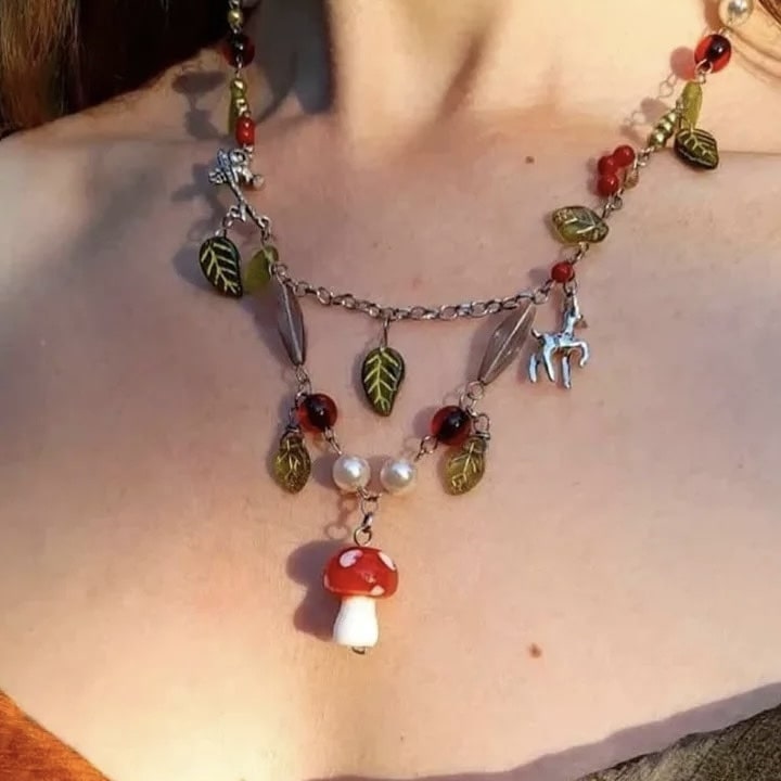 Cottagecore jewelry featuring a red mushroom charm