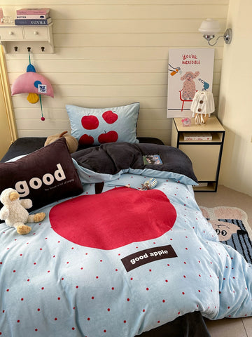 Apple print fleece bedding set displayed on bed in cozy warm dorm room interior