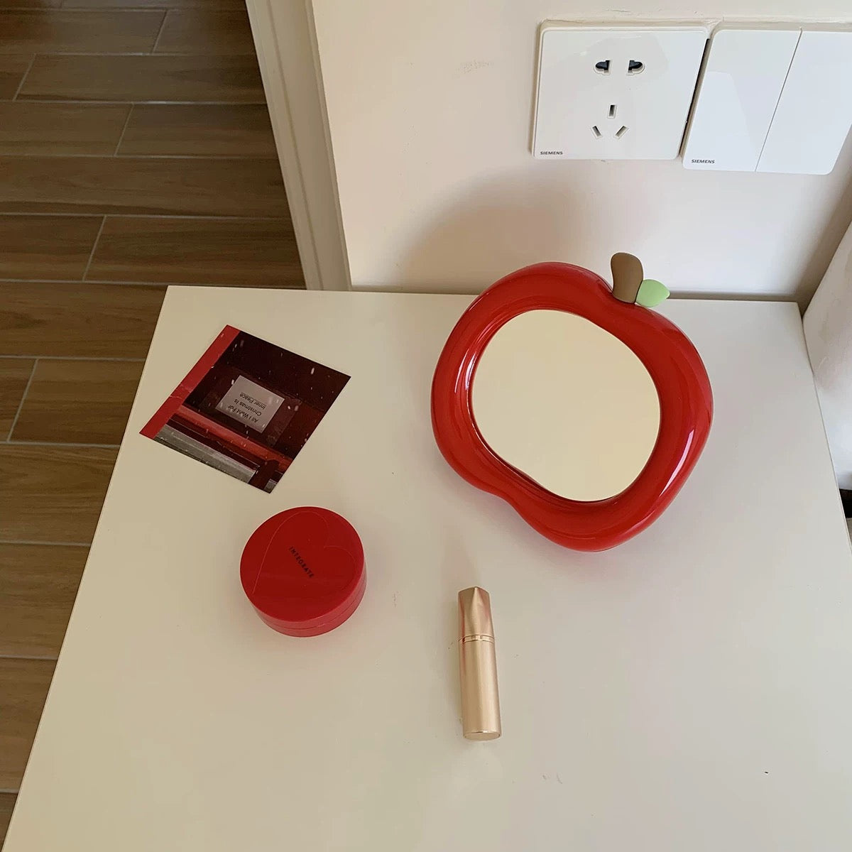 Mirror in apple shape on vanity table for aesthetic room styling