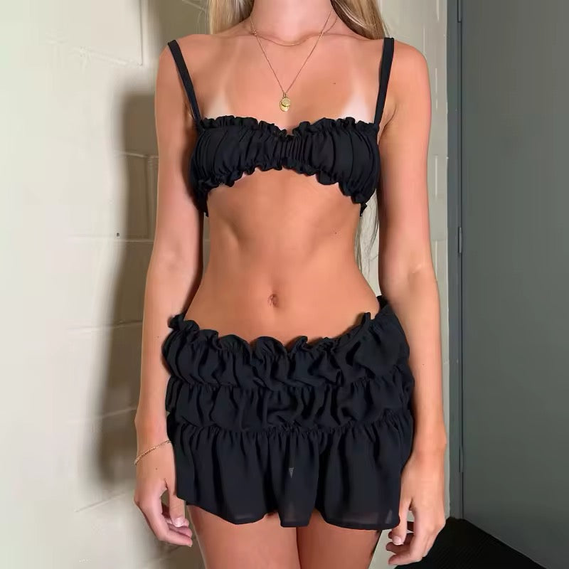 Two-piece coquette beach outfit with skirt and spaghetti strap top