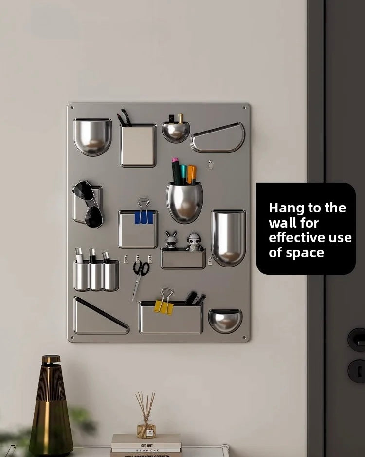 Metal wall organizer with various compartments on a white wall.