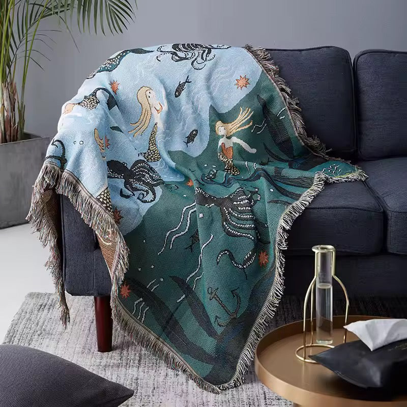 Mermaid-themed blanket draped over a sofa in a living room setting