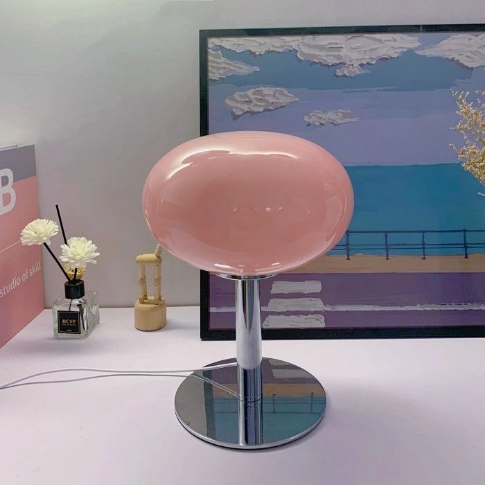 Modern glass lollipop lamp on a living room side table