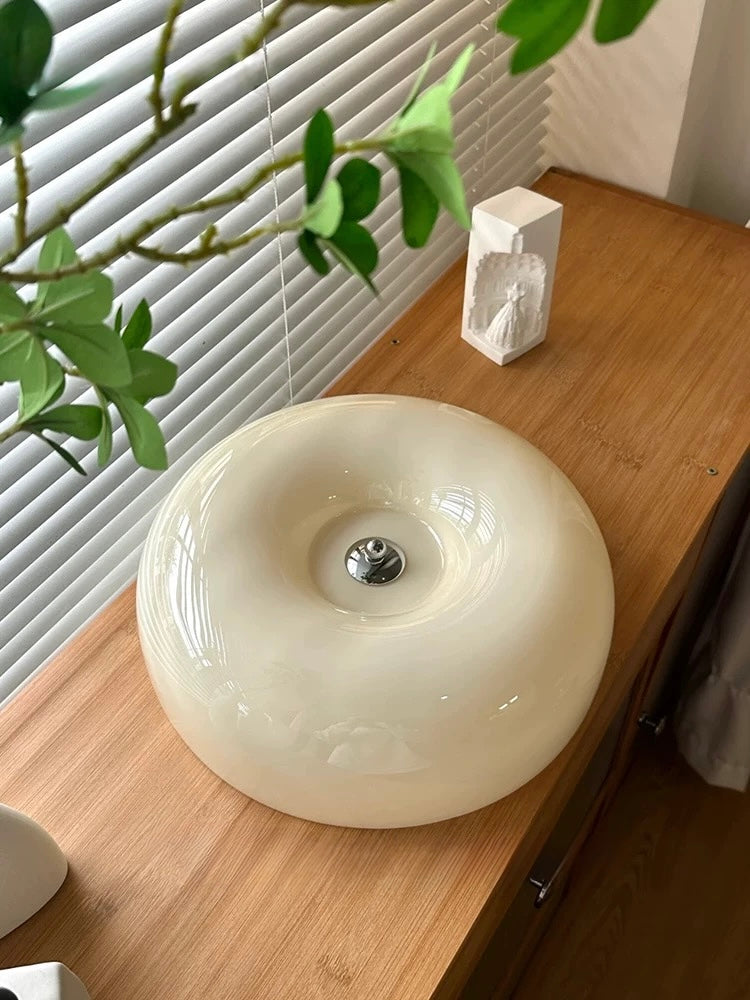 Ceiling light fixture in a room with an air conditioning unit below