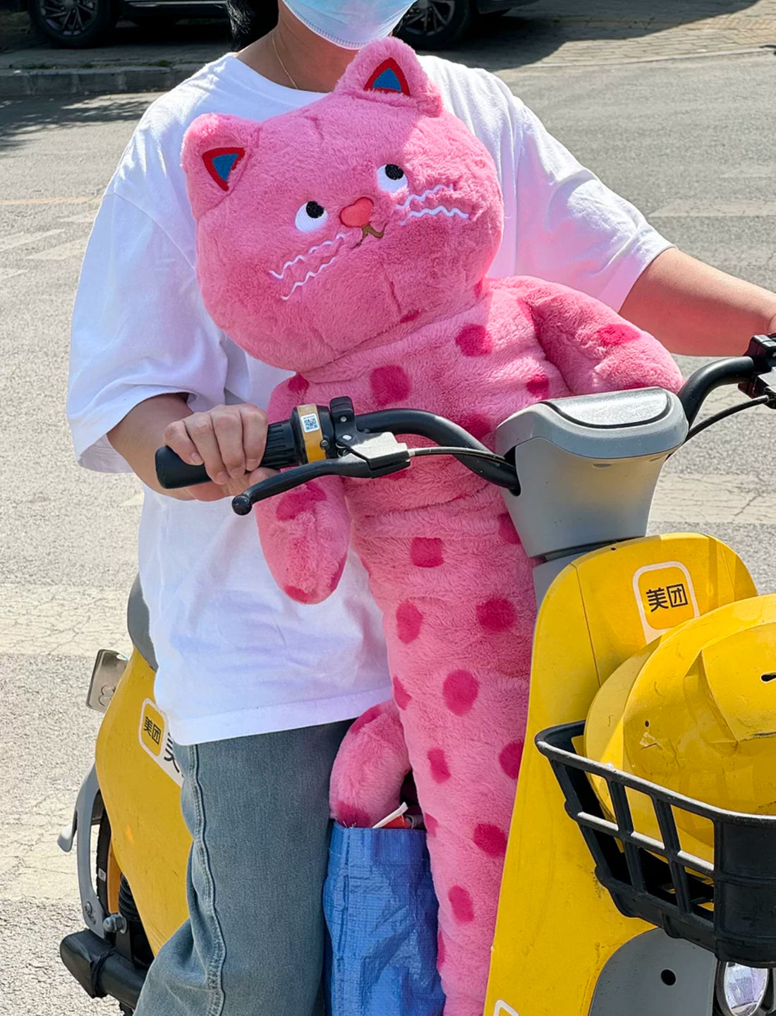 Soft pink cat plush toy with polka dots for cozy room decor