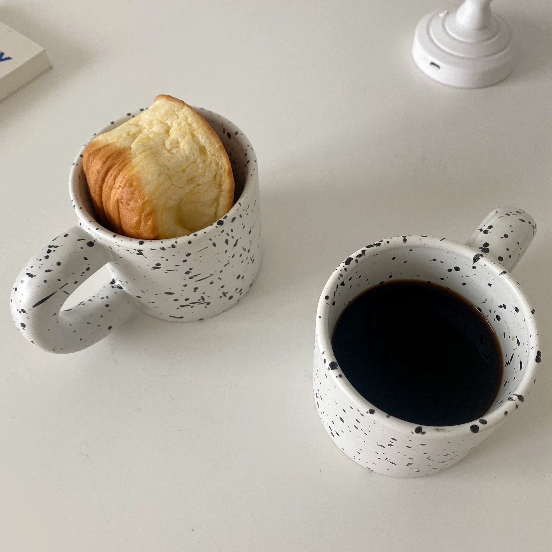 Ceramic coffee tumbler with black dot pattern