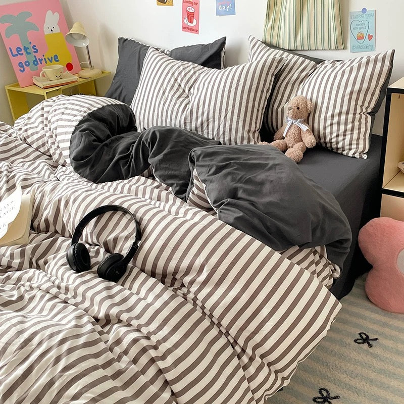 Cozy black stripe duvet cover set styled with teddy bear decor and minimal wall art.