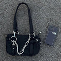 Fashionable shoulder bag with chain decor and grunge vibe