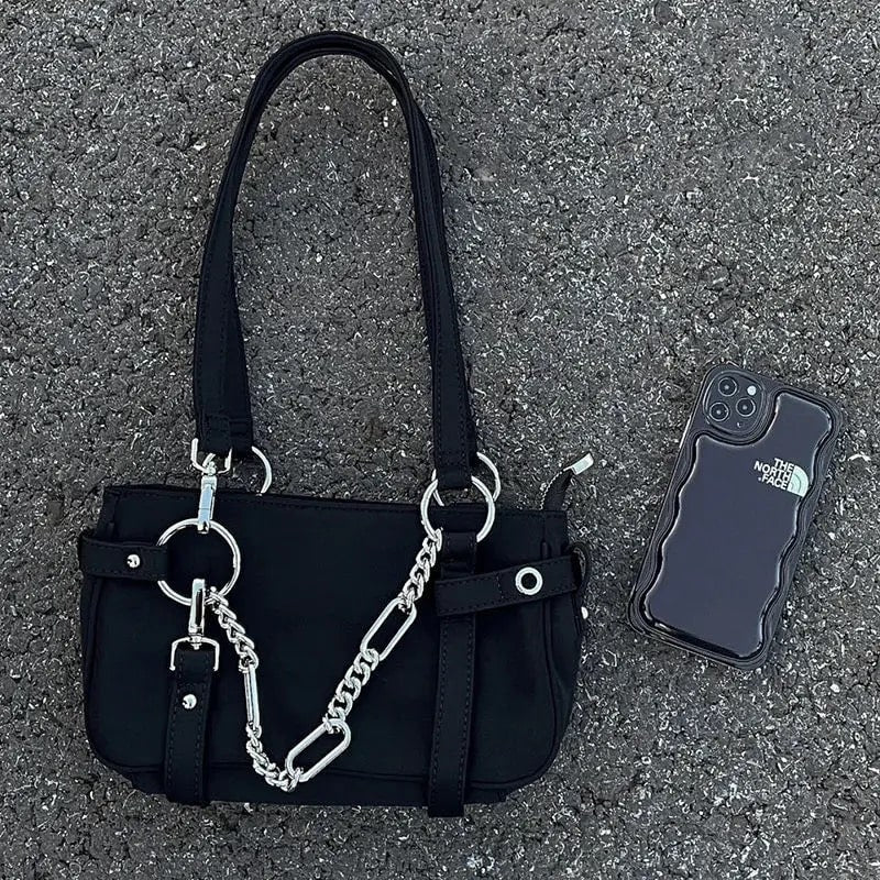 Fashionable shoulder bag with chain decor and grunge vibe