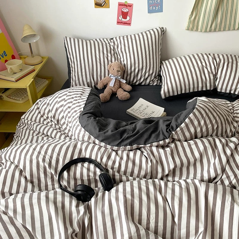 Modern black striped duvet cover set with matching pillows on a college dorm bed.