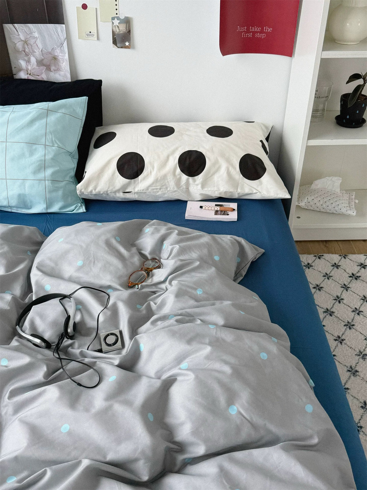 Blue check and large black dot pillowcases above a folded gray dotted cover.