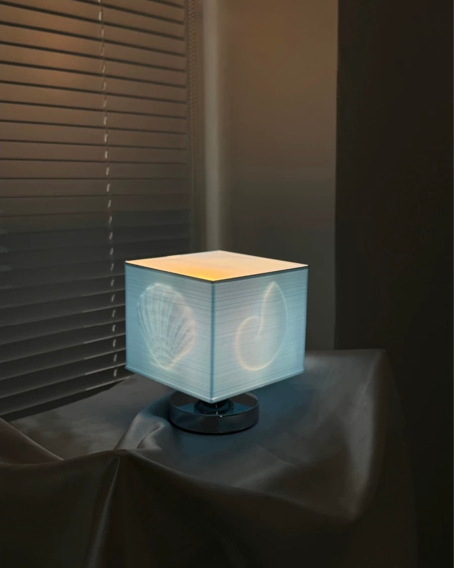 Decorative blue seashell table lamp creating calm mermaidcore vibes on a modern bedside table