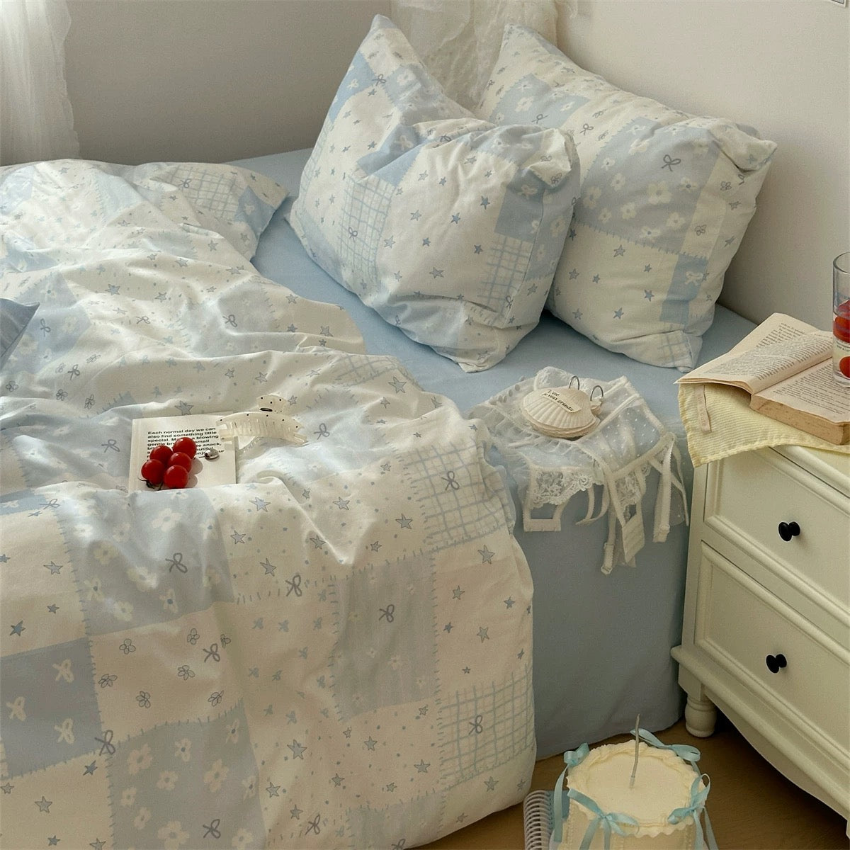Blue patchwork duvet cover with star and bow details styled for soft girl decor.