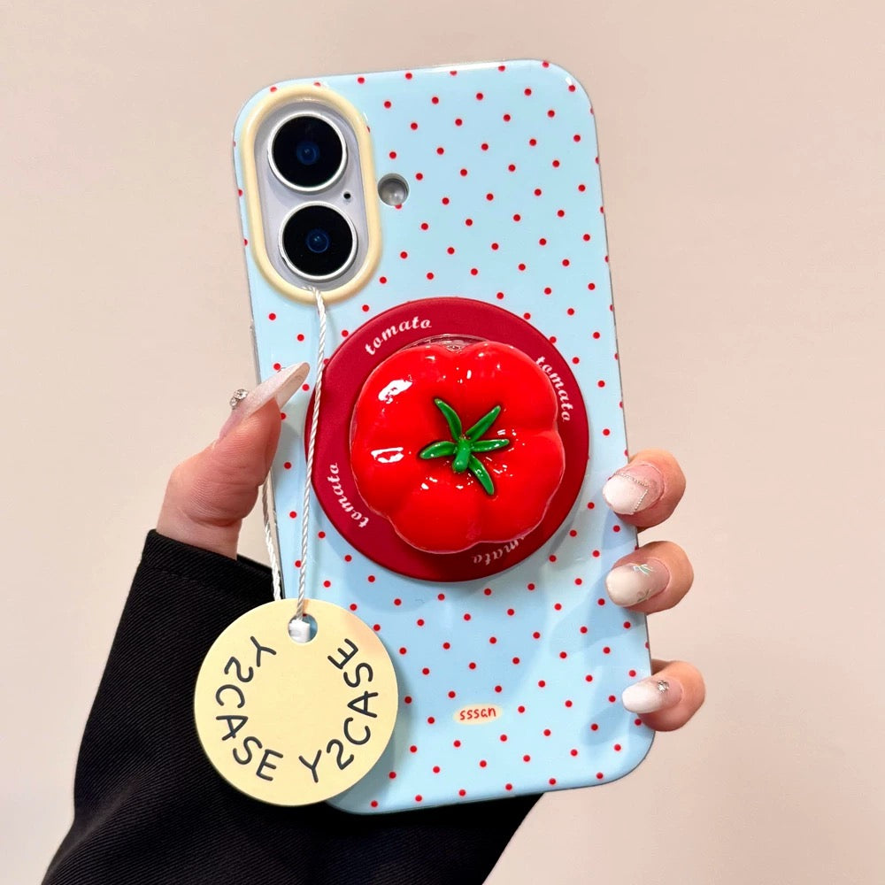 Phone case with tomato design and popsocket held by a hand