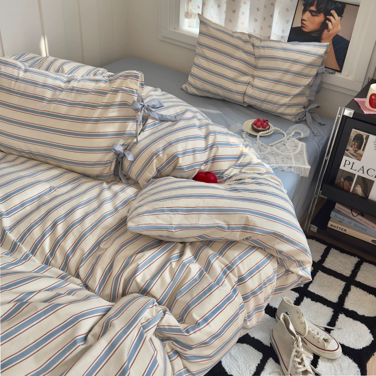 Striped cotton comforter on neatly made bed with beige accents