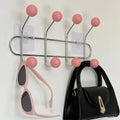 Pink door back hanging rack for storing backpacks and towels